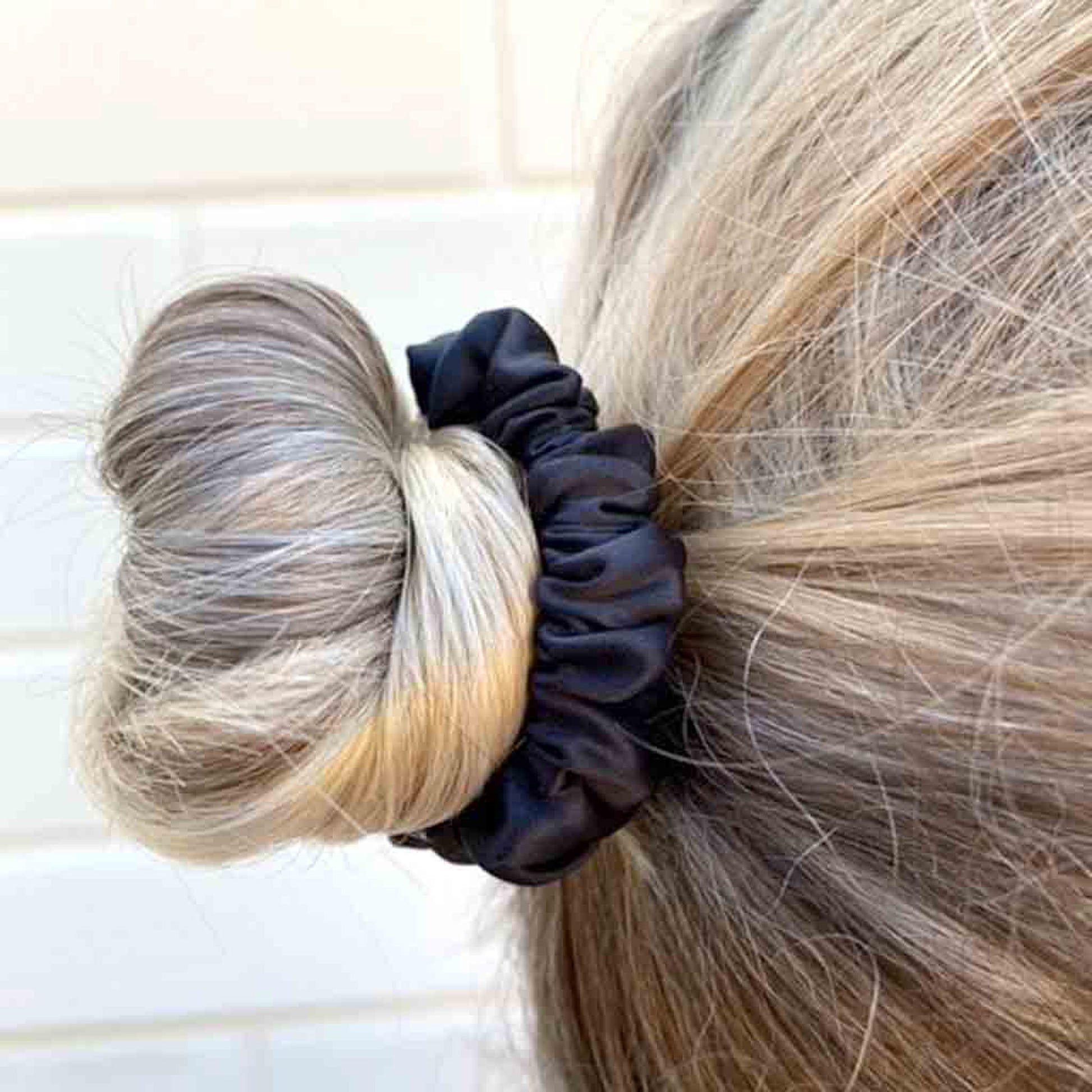 Woman wearing a black silk scrunchie in her hair
