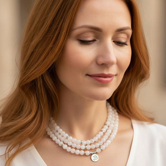 Woman wearing a white crystal mala bead bracelet with 108 beads