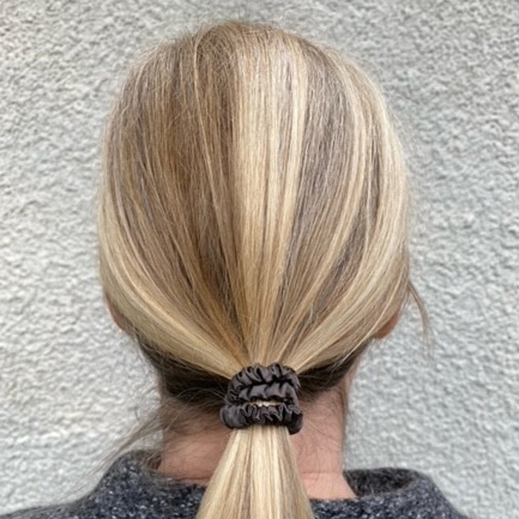 Skinny charcoal grey silk scrunchie made from 100% Mulberry silk, shown on white background