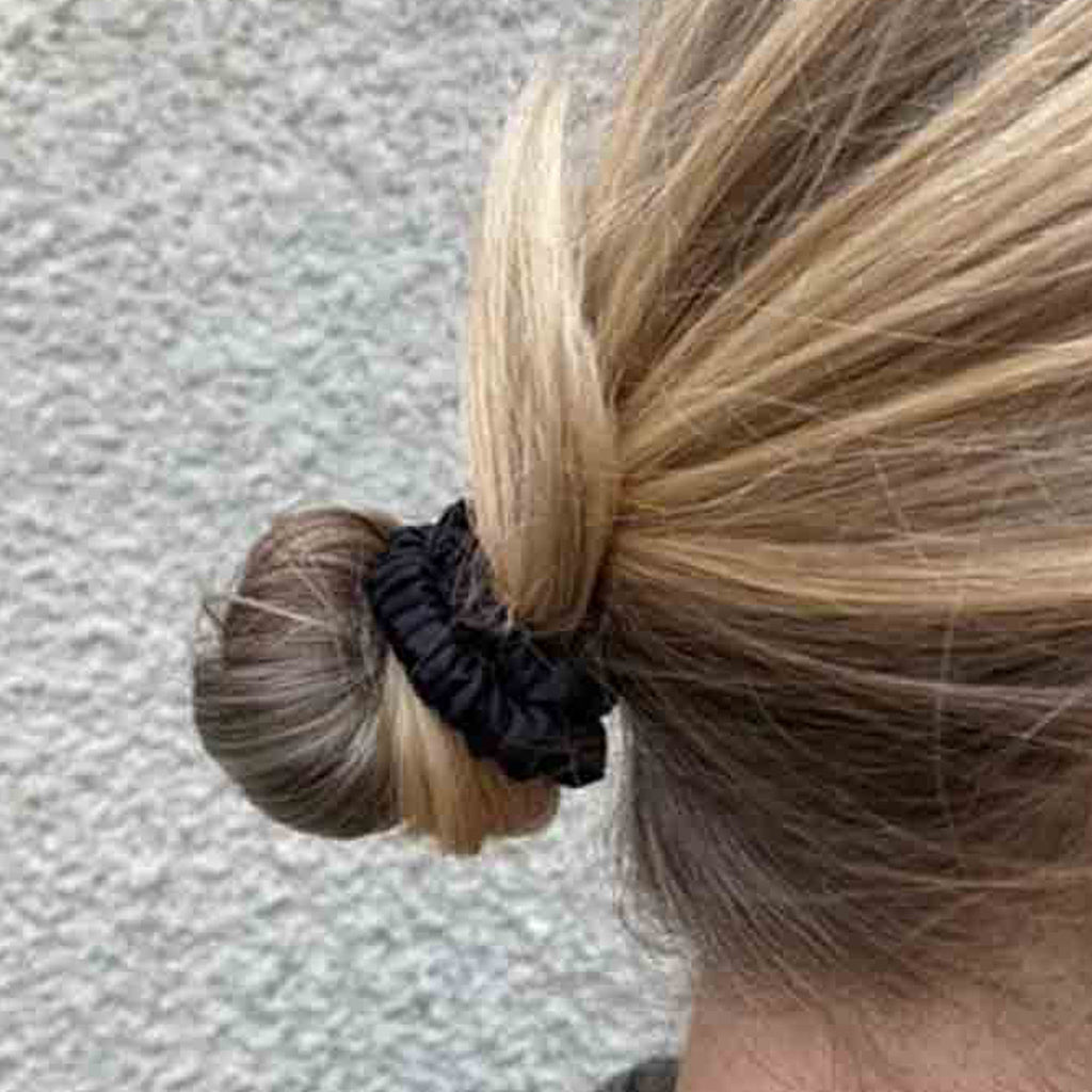 Woman wearing a black silk scrunchie in her hair