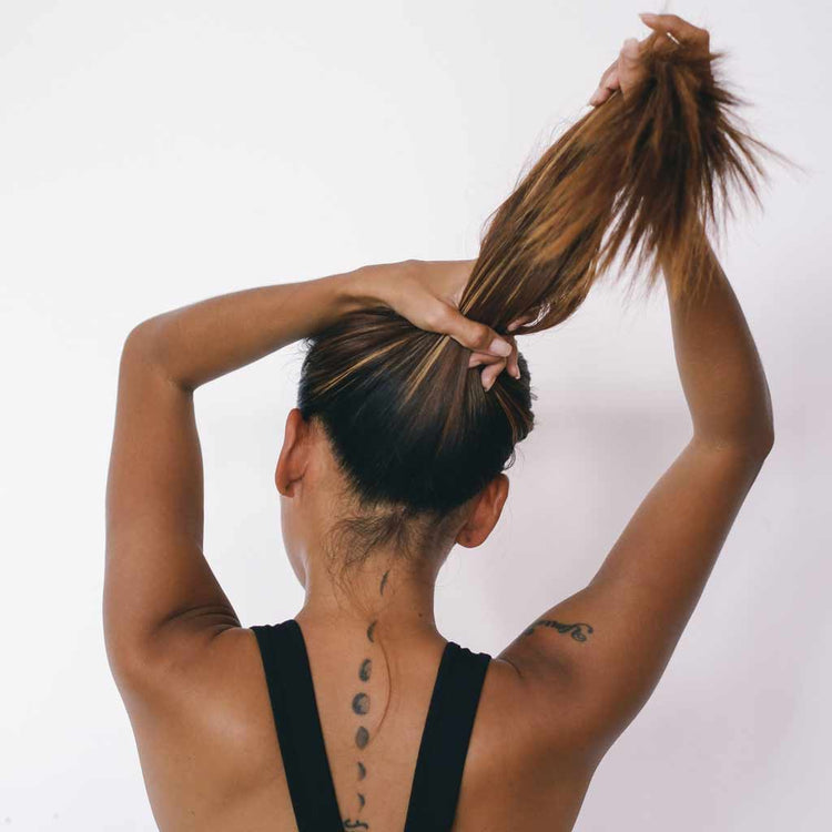 Woman about to put on a silk scrunchie hair tie