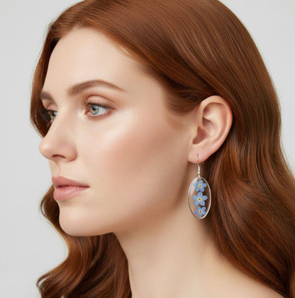 Woman wearing floral earrings with a neutral background