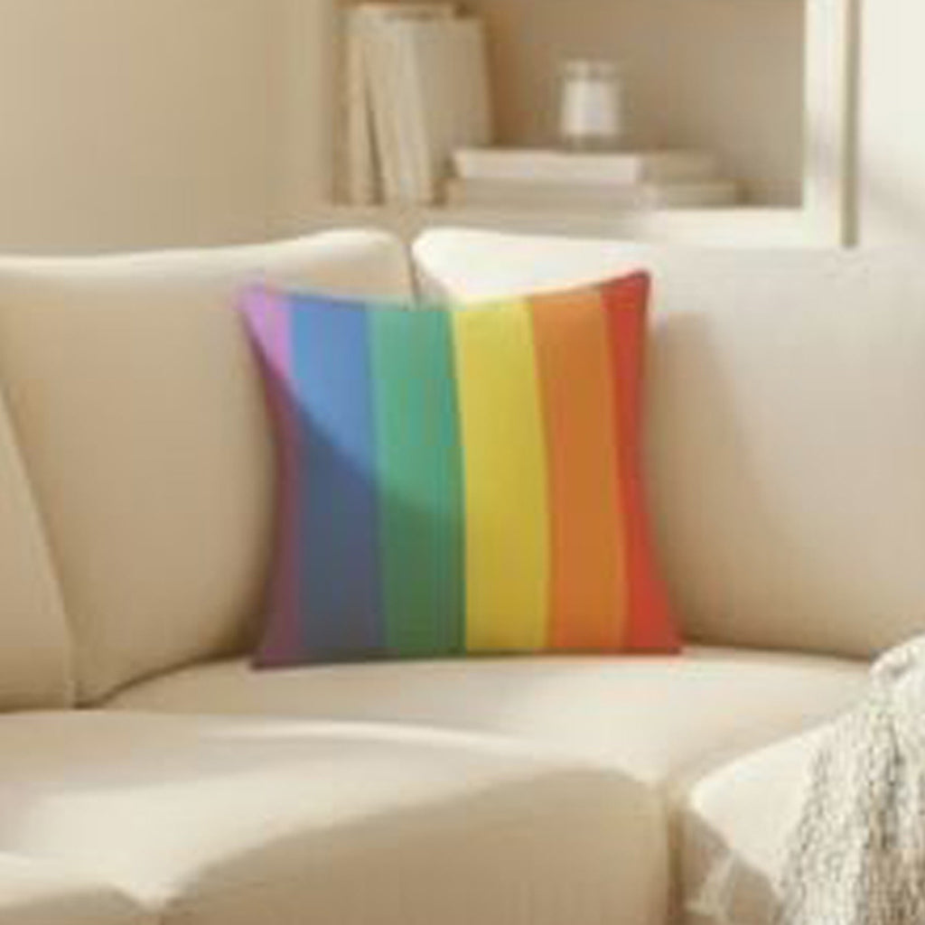 Rainbow striped pillow on a beige sofa