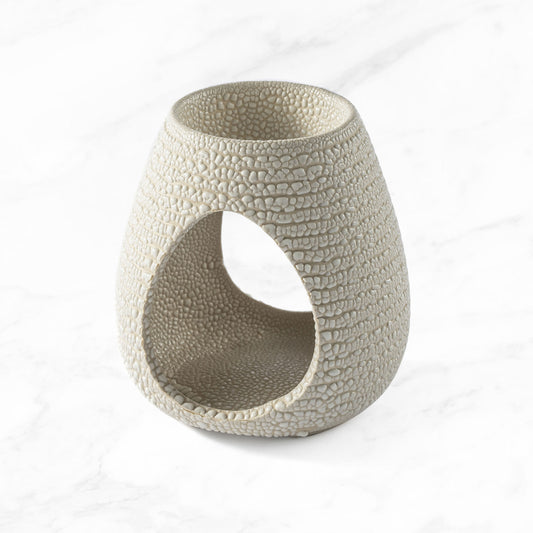 Myga Beehive Ceramic Oil Burner in cream with a textured honeycomb pattern and a wide oval opening for a tea light candle.