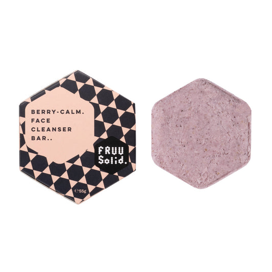 Fruu Berry-Calm Face Cleanser Bar in hexagonal checkered packaging alongside the solid purple-tinted berry cleansing bar.