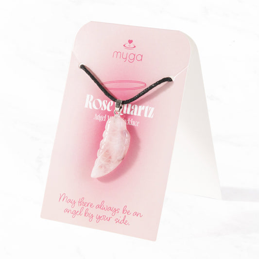 Pale pink rose quartz angel wing pendant on an adjustable black cord, displayed on a pink Myga card that reads "May there always be an angel by your side."