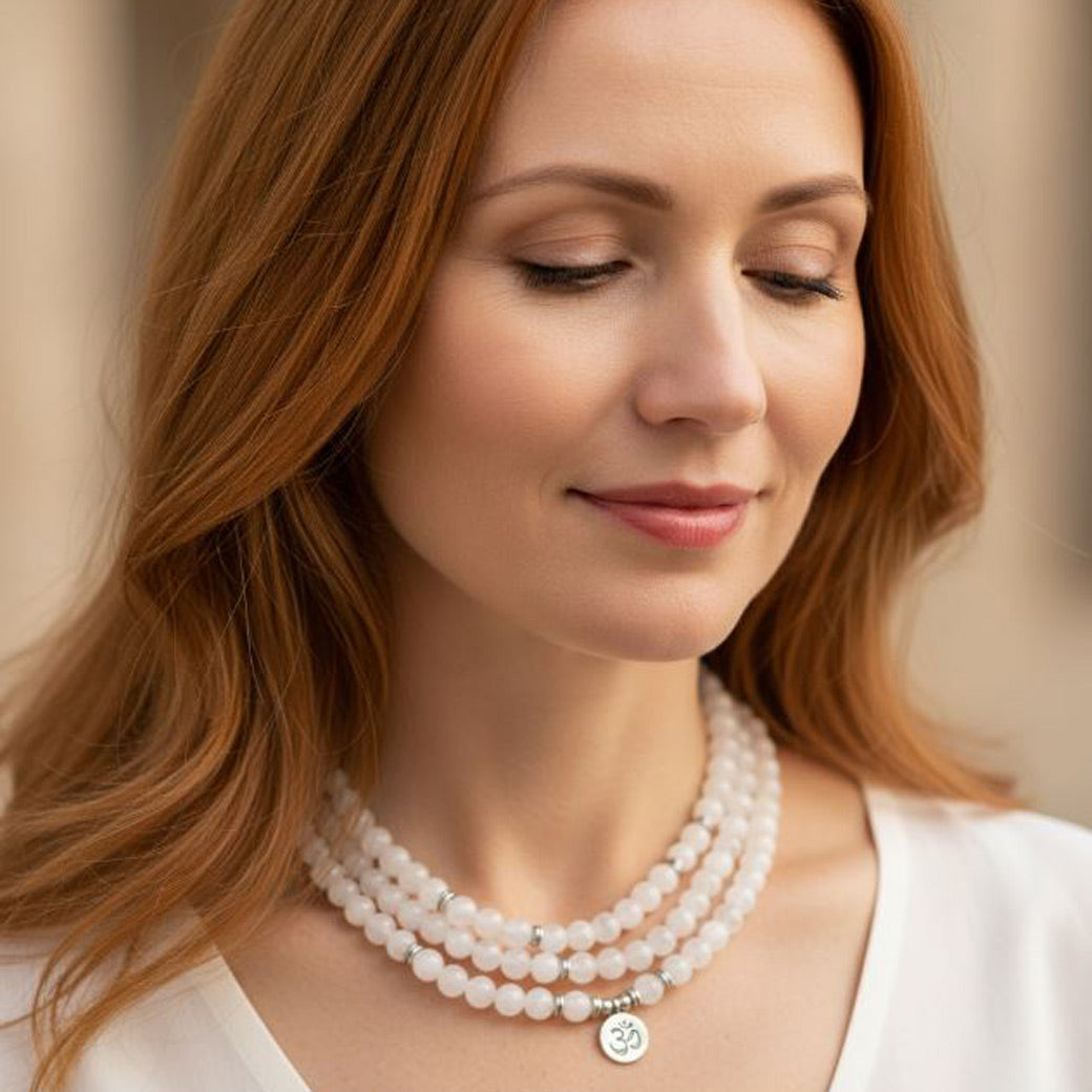Woman wearing a white crystal mala bead bracelet with 108 beads