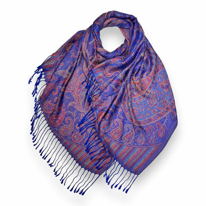 A vibrant royal blue and multi-tonal jacquard paisley pashmina scarf made from a 50% cotton and 50% viscose blend, draped to show the intricate reversible pattern and classic tassel ends.