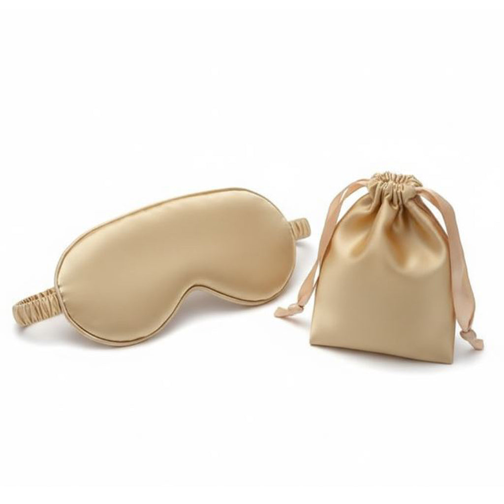 Gold satin eye mask with matching drawstring bag on a white background