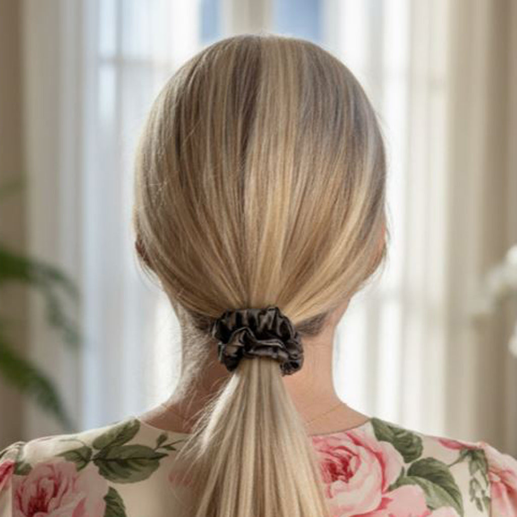Person with a ponytail wearing a charcoal grey mulberry silk scrunchie