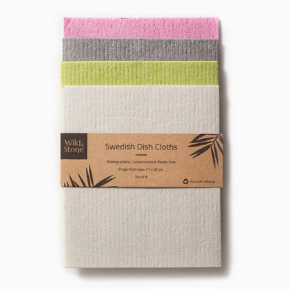 Set of 4 Wild and Stone Swedish Dish Cloths in pink, grey, lime green, and white. Biodegradable, plastic-free, and compostable eco-friendly kitchen cloths with sustainable cardboard packaging.