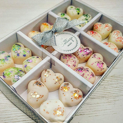 Luxury soy wax melt gift set box open showing 6 hand-poured scents: Black Pomegranate, English Pear & Freesia, Tonka & Myrrh