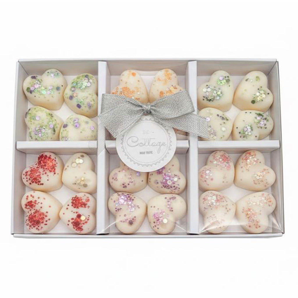 Luxury soy wax melt gift set box open showing 6 hand-poured scents: Black Pomegranate, English Pear & Freesia, Tonka & Myrrh