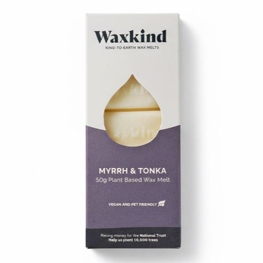Front of white and deep purple Waxkind packaging. A droplet-shaped cutout reveals a light-coloured wax melt bar. Text reads: Waxkind Kind-To-Earth Wax Melts, Myrrh & Tonka, 50g Plant Based Wax Melt, Vegan and Pet Friendly.