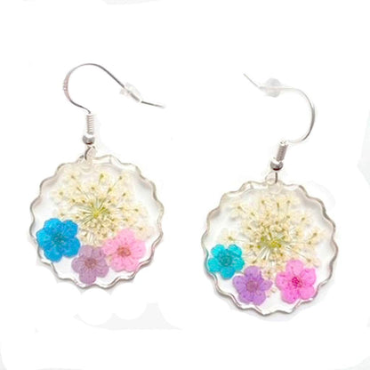 Sterling silver earrings with three forget me not real flowers encased in resin